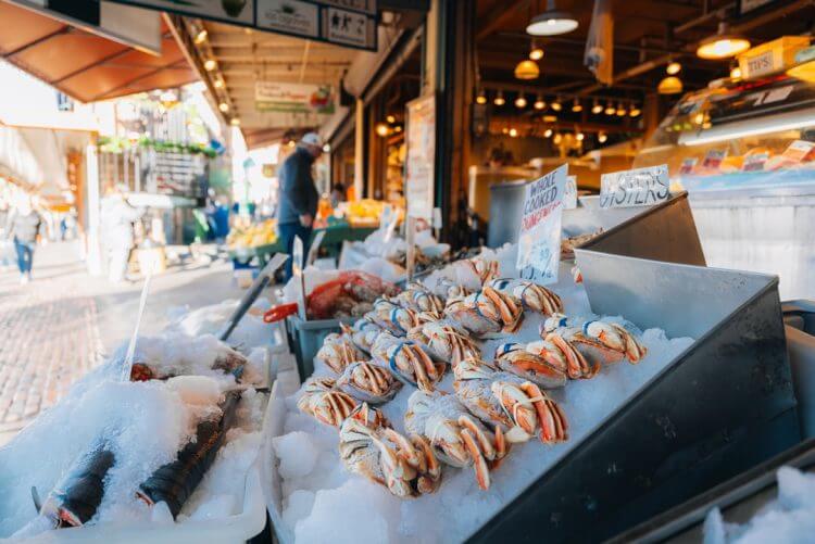 Fresh seafood displayed on ice at a market.
