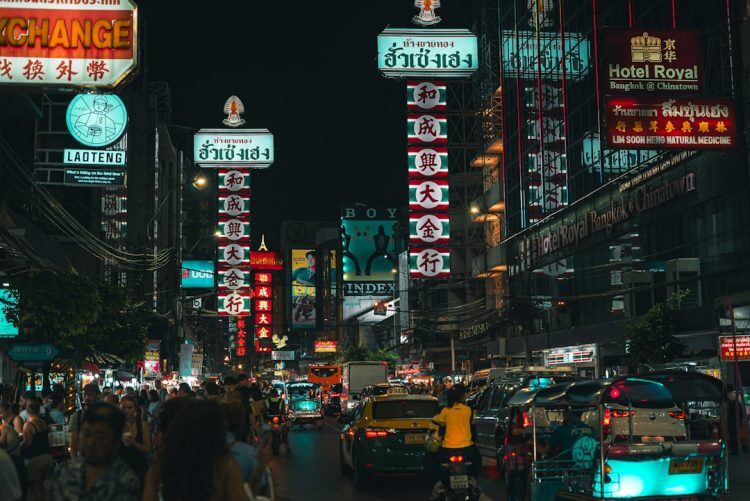 Busy street with neon signs and traffic at night