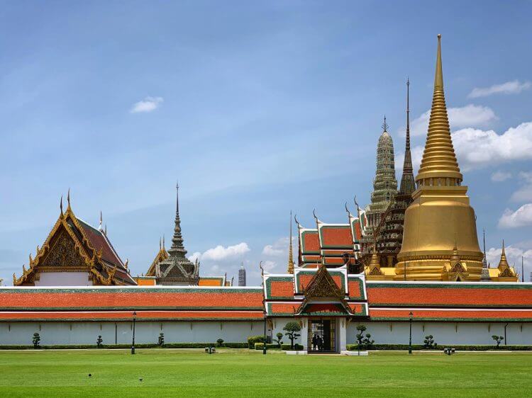Explore the iconic Grand Palace in Bangkok with its golden spires and traditional Thai architecture.