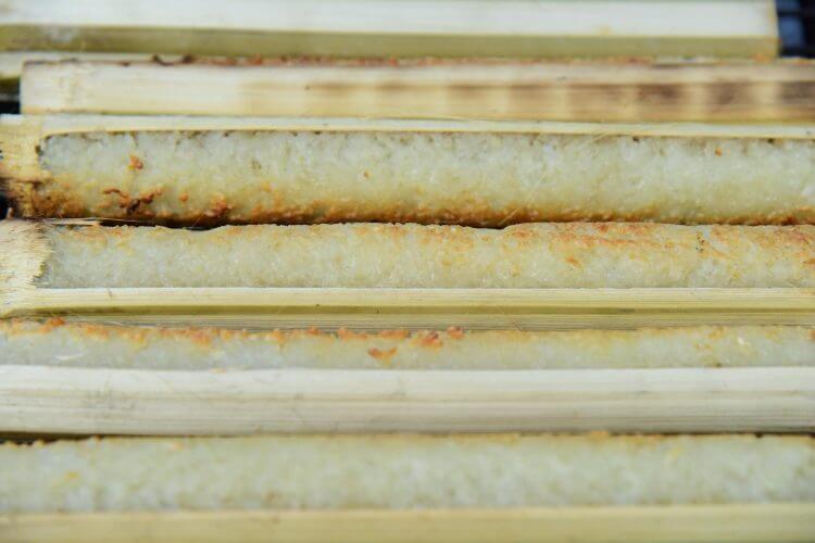 Close-up of traditional bamboo cooked sticky rice, a popular Southeast Asian delicacy.