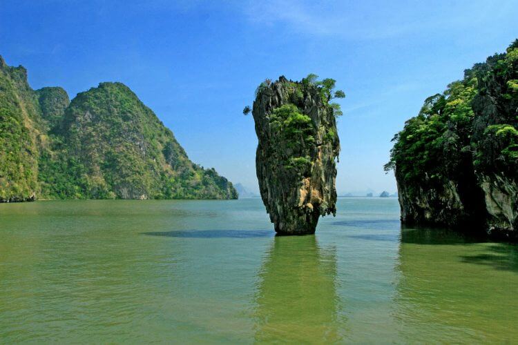 A stunning view of James Bond Island in Thailand's Phang Nga Bay with clear blue skies.