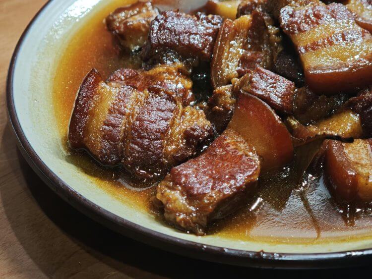 Savor the taste of tender braised pork belly in a rich, flavorful sauce.