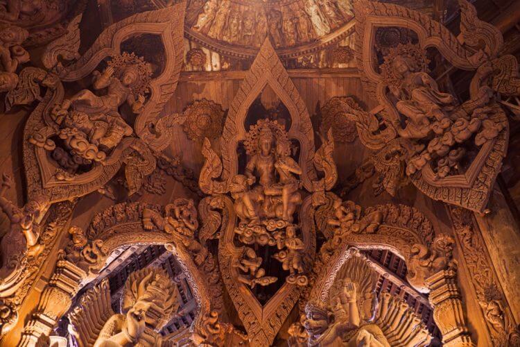 a large ornate wooden structure with statues on it