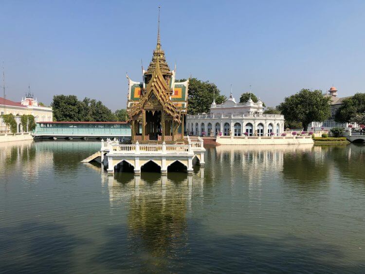 A picturesque view of the unique pavilion at Bang Pa-In Royal Palace with reflections in the water.