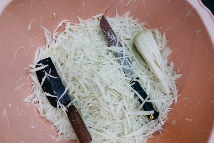a bowl of noodles with a knife