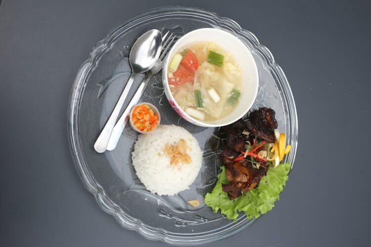 A meal with rice, soup, and grilled meat