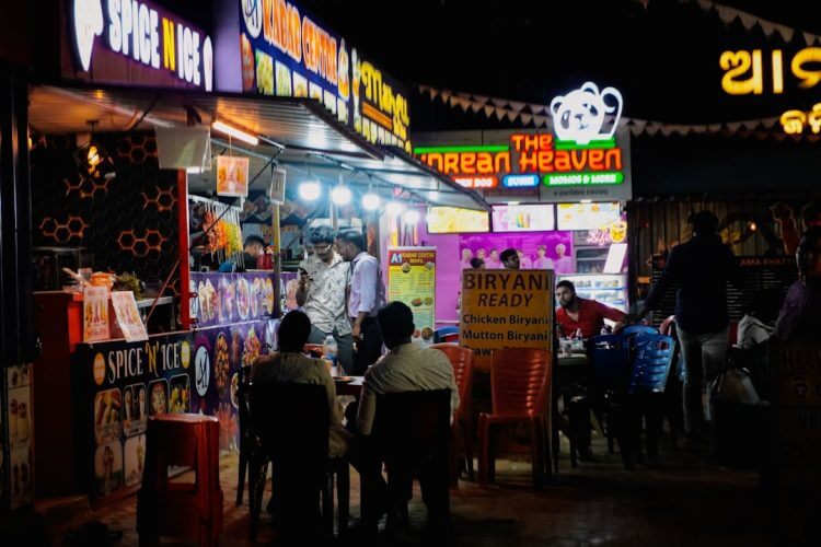 Street food stalls at night with people eating