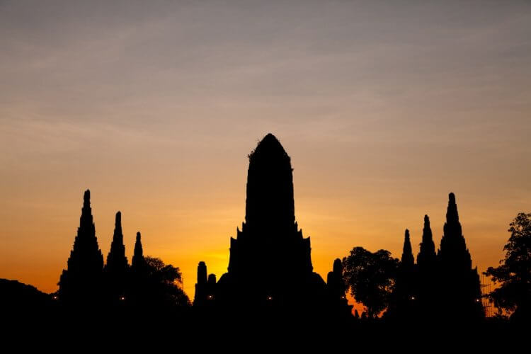 Silhouette of ancient temple ruins at sunset