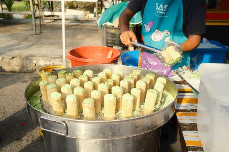 A street vendor prepares steamed desserts.