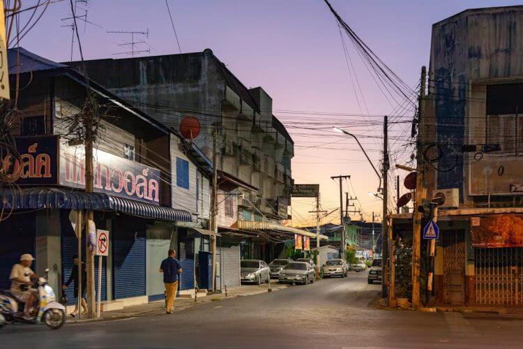 Street scene with buildings and cars at dusk