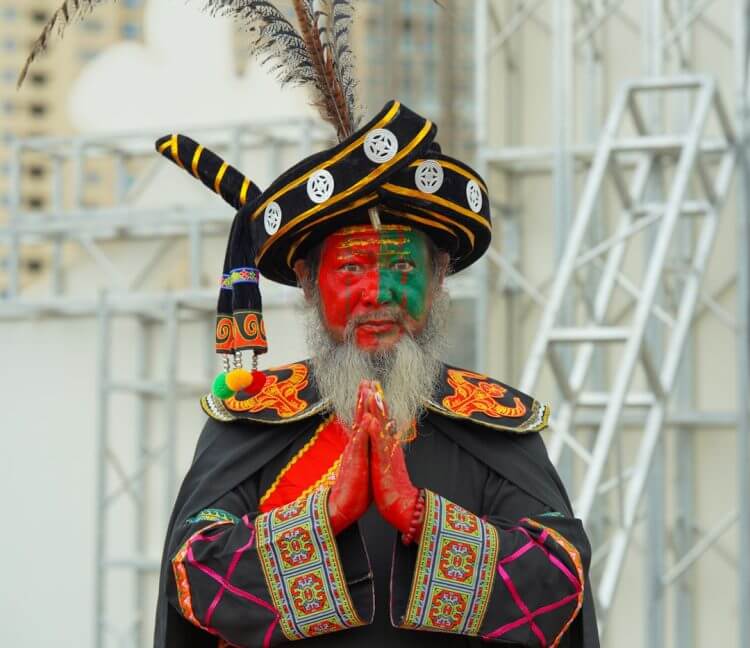 Performer in traditional costume with painted face