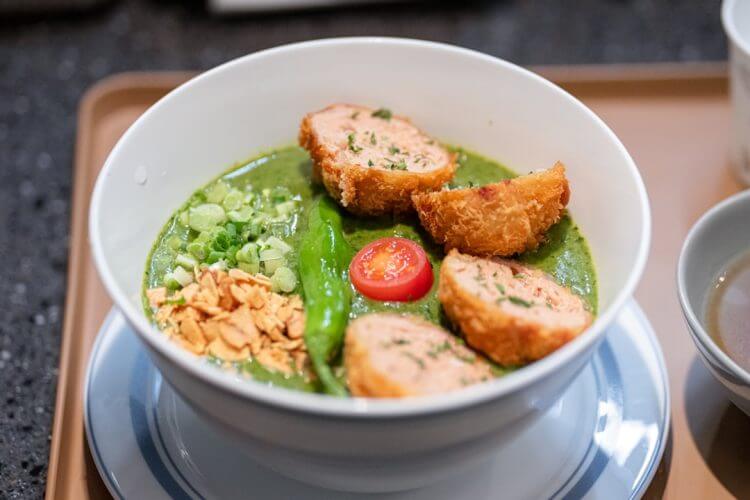 a white bowl filled with food on top of a table