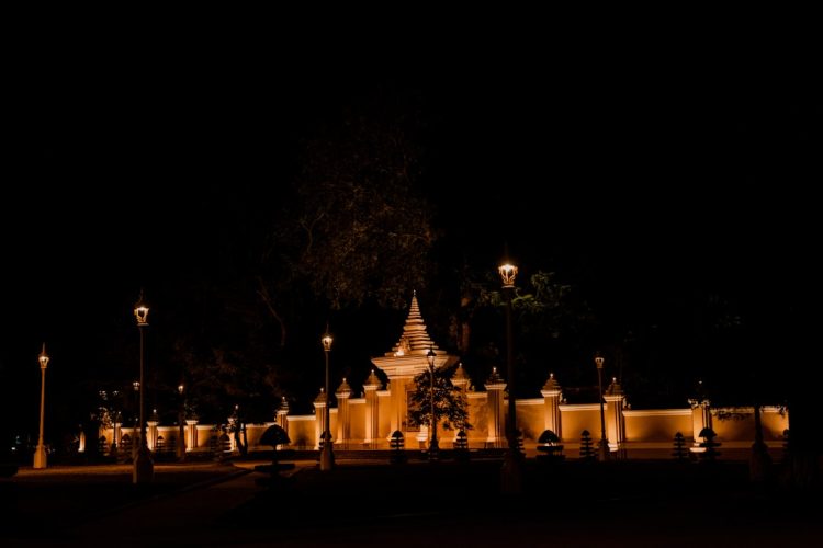 a building lit up at night with street lights