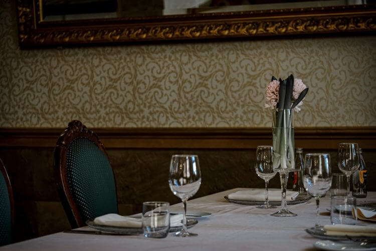 A table set for a meal with wine glasses.