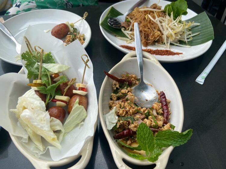Delicious Thai dishes served outdoors in Bangkok, Thailand, showcasing vibrant flavors and fresh ingredients.