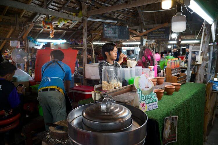 People at a busy outdoor food market stall