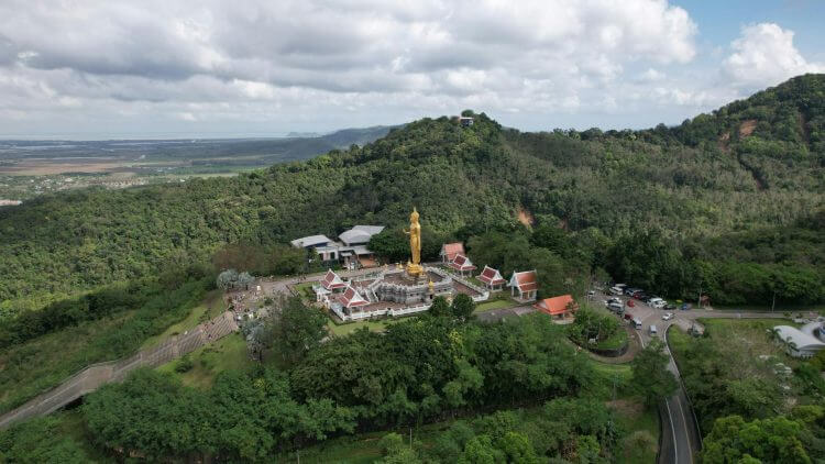 A stunning aerial shot of the Golden Buddha statue surrounded by lush greenery in Kho Hong, Thailand.
