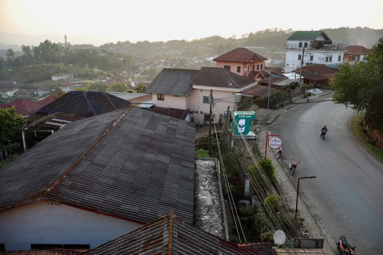 A winding road through a small town at dusk.