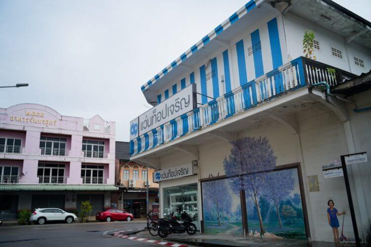 Buildings with blue and white stripes and mural.