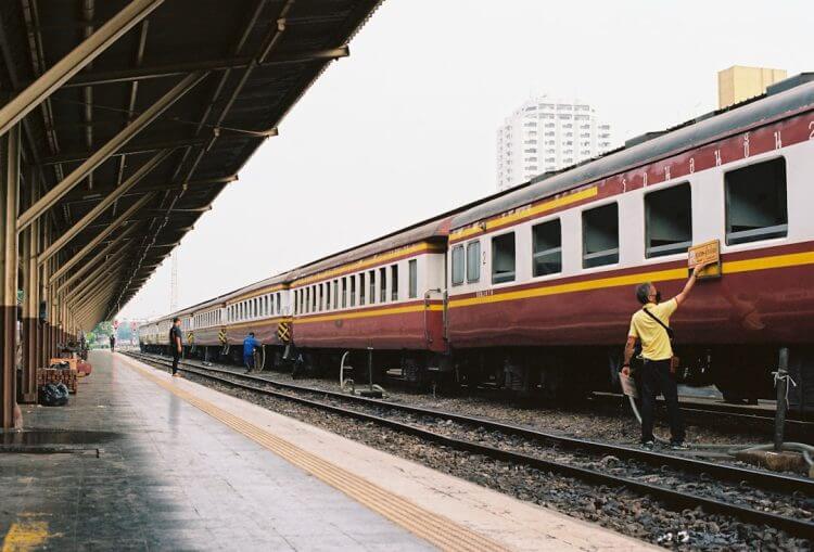 A man standing next to a train at a train station
