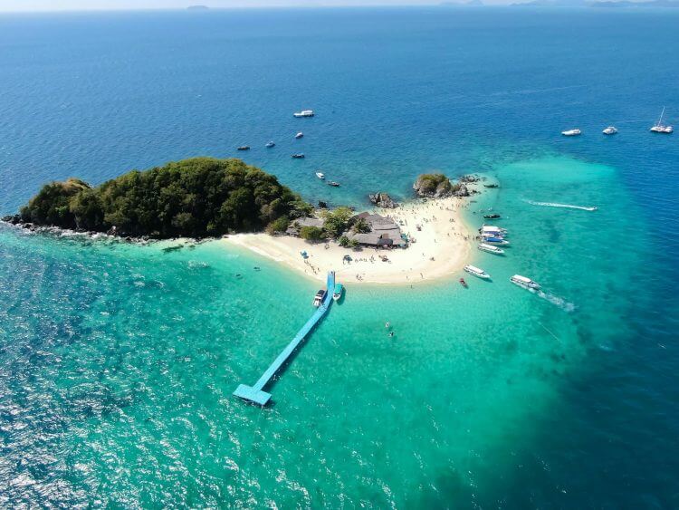 Idyllic aerial view of Koh Khai Nai Island's turquoise waters and sandy beaches in Phuket, Thailand.