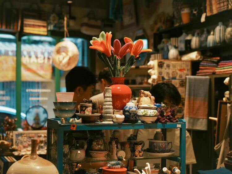 Lively Bangkok shop featuring vibrant ceramics and textiles, creating a warm artisan atmosphere.