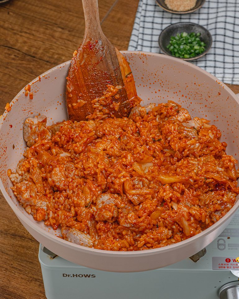 ข้าวผัดกิมจิ ขั้นที่ 6: ผัดคลุกทุกอย่างให้เข้ากันบนไฟปานกลาง กลับข้าวจากก้นกระทะขึ้นมาเรื่อยๆ กันซอสไหม้…