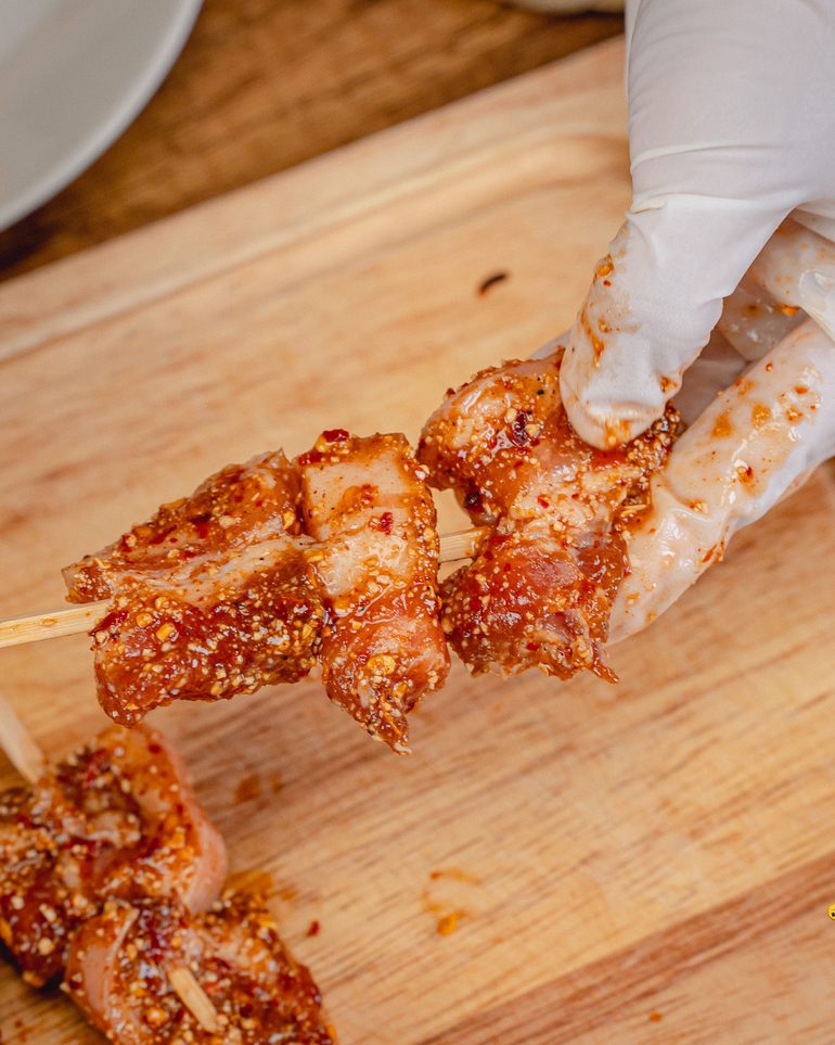สามชั้นข้าวคั่ว (หม้อทอด) ขั้นที่ 6: เมื่อหมักได้ที่แล้ว นำหมูมาเสียบไม้ ไม้ละประมาณ 4–5 ชิ้น…